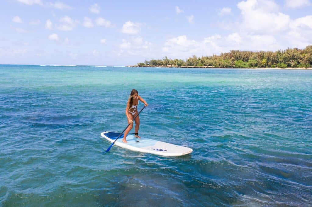 a man riding a wave on a surf board on a body of water