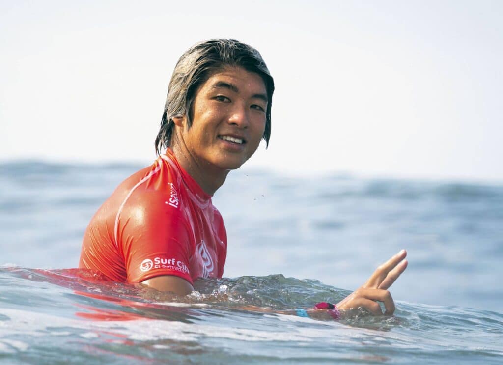 Hiroya Saito riding a wave on top of a body of water