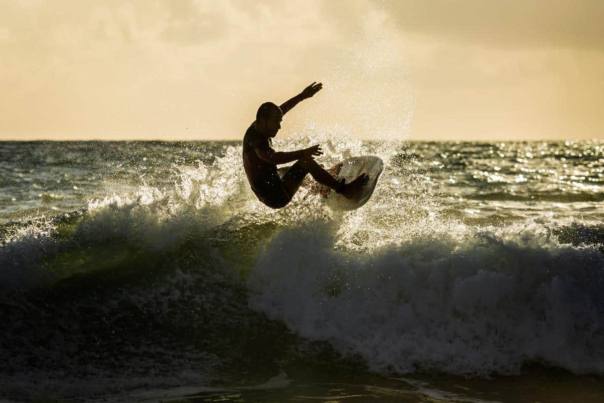 a man riding a wave on a surfboard in the ocean
