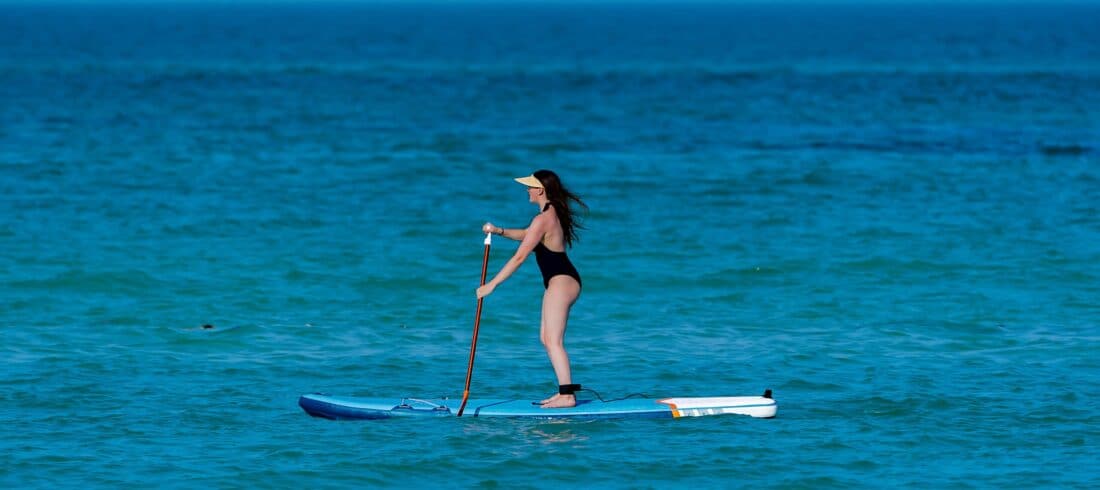 a person riding a surf board on a body of water