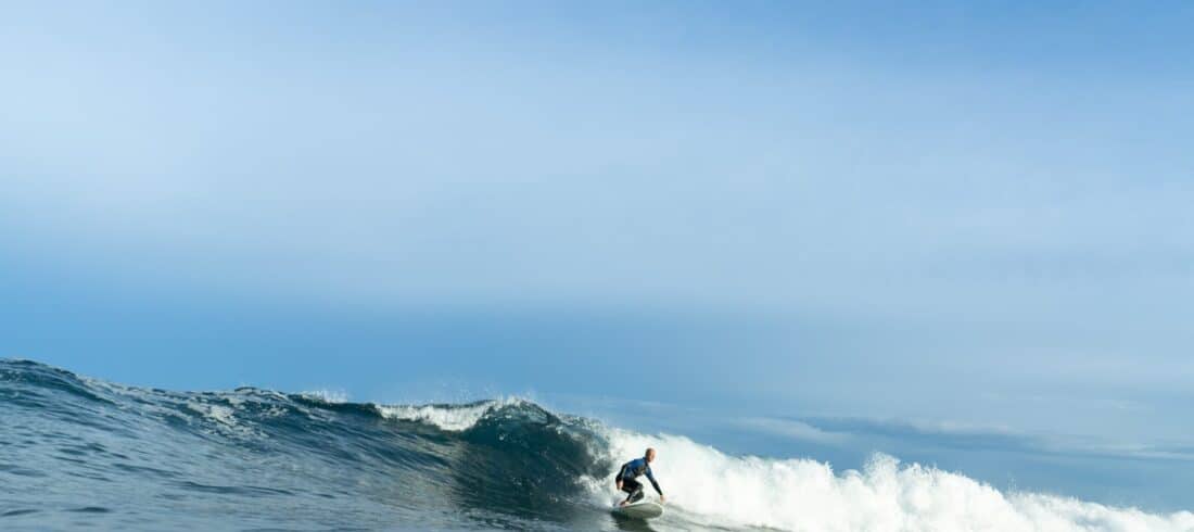 a man riding a wave on a surfboard in the ocean