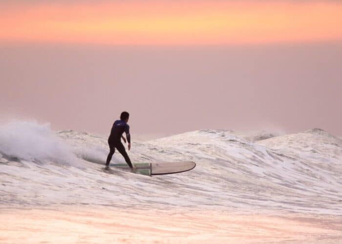 a man riding a wave on a surfboard in the water