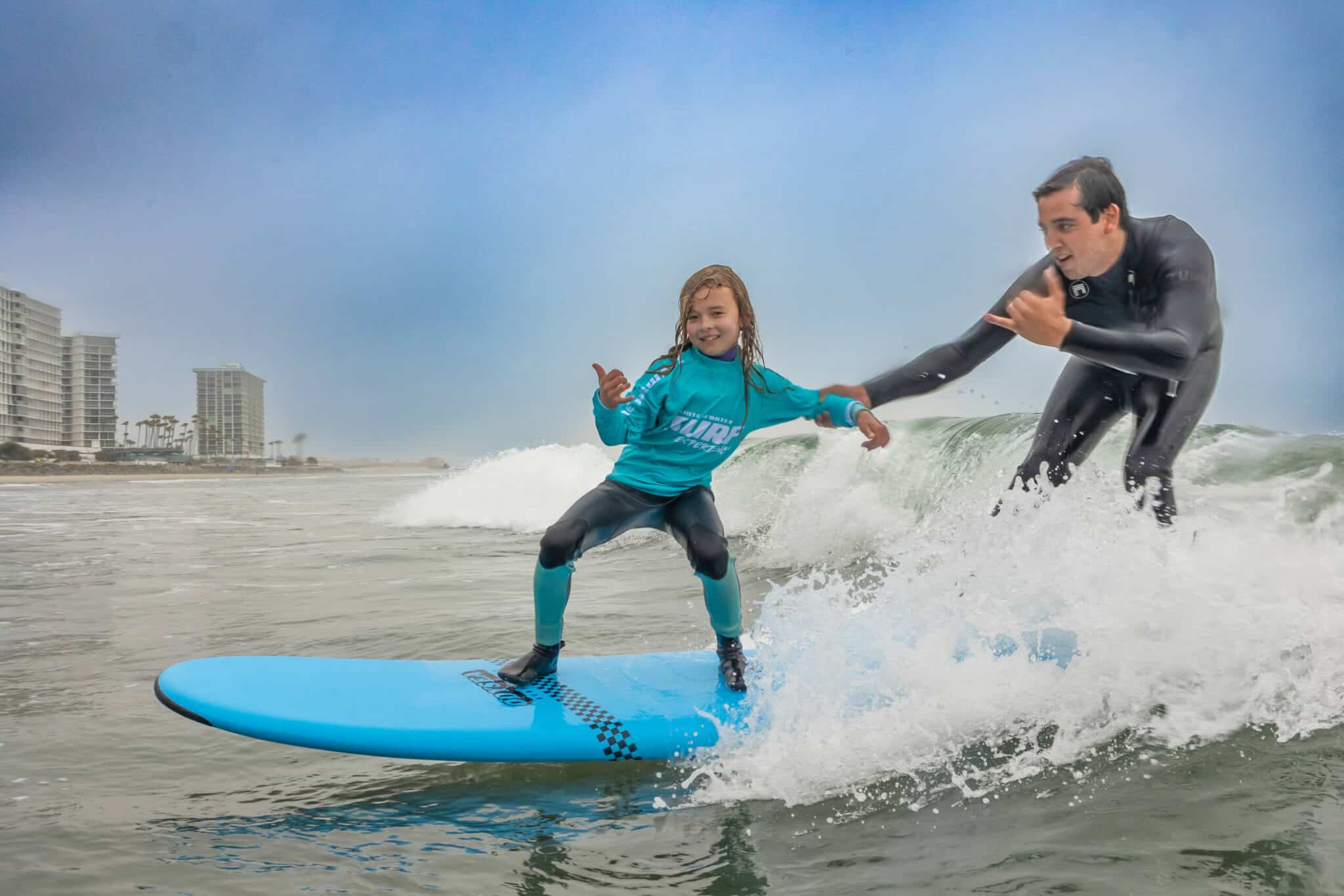 a girl riding a wave on a surfboard in the water