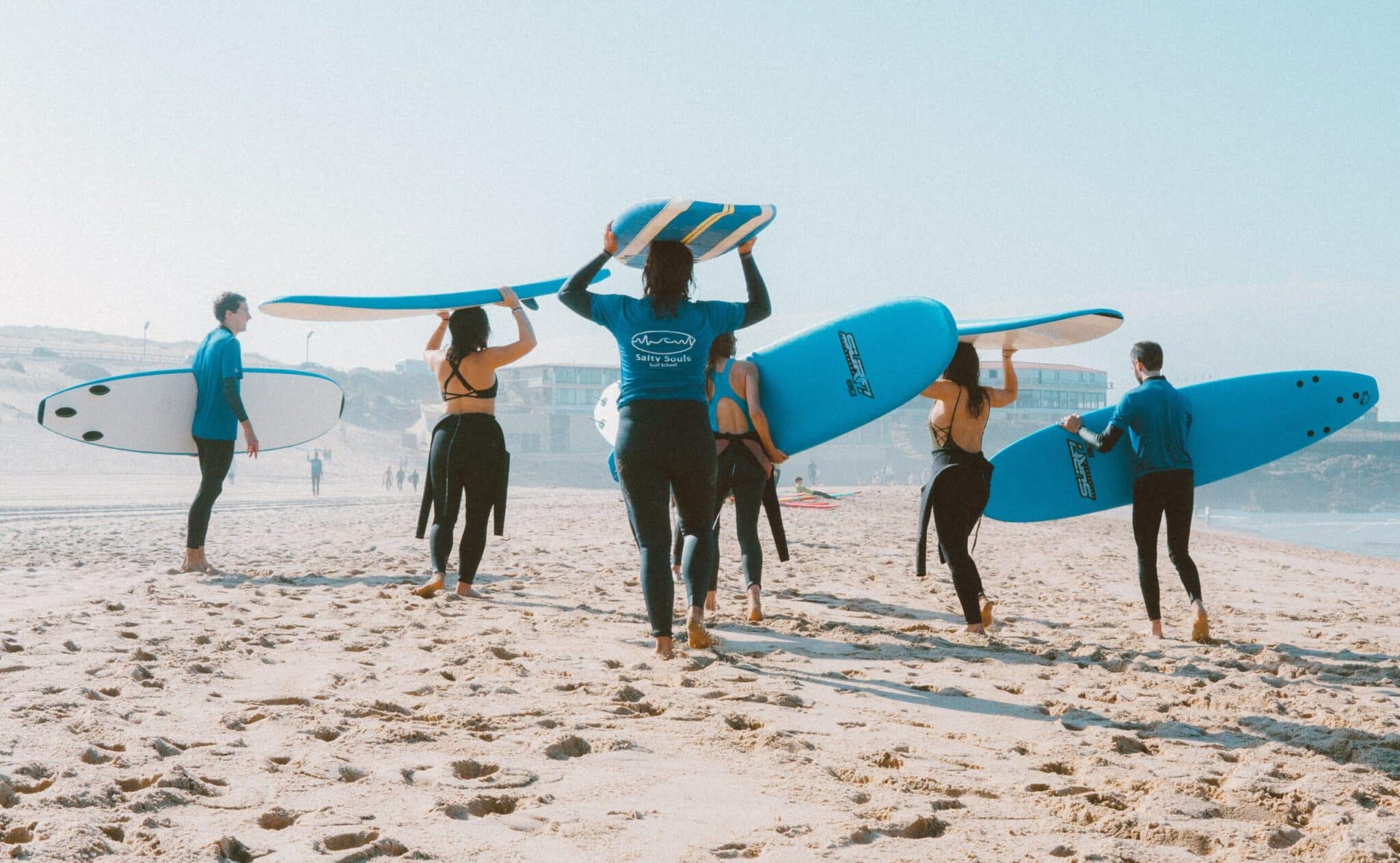 a group of people walking on a beach