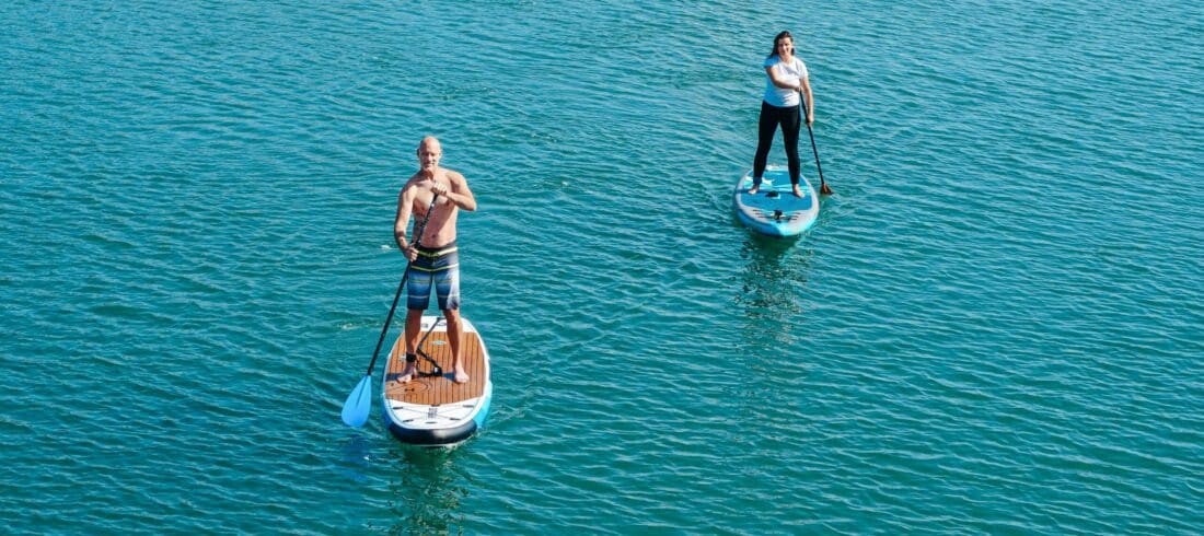 a man riding on the back of a boat in a body of water