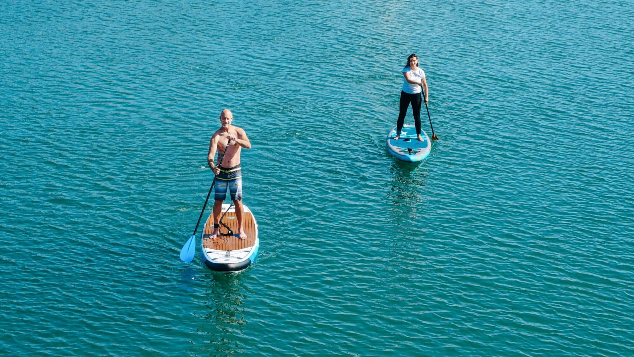 a man riding on the back of a boat in a body of water