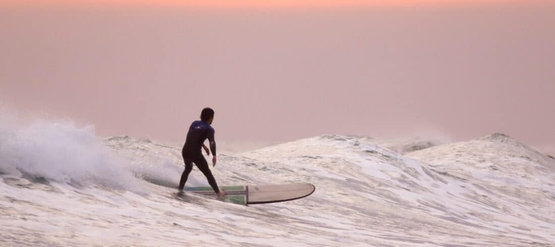 a man riding a wave on a surfboard in the water