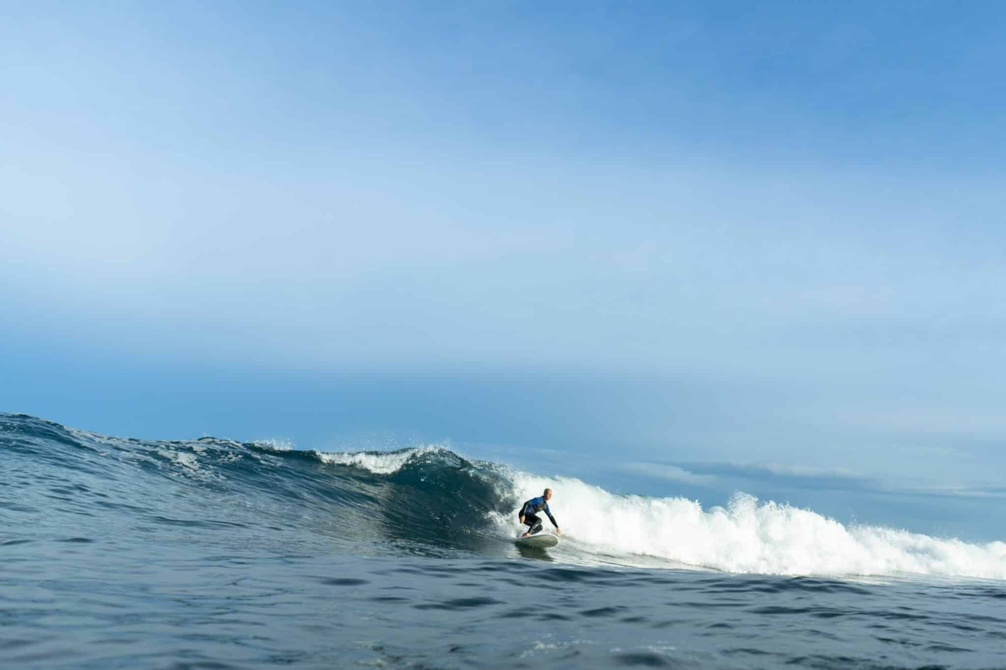 a man riding a wave on a surfboard in the ocean