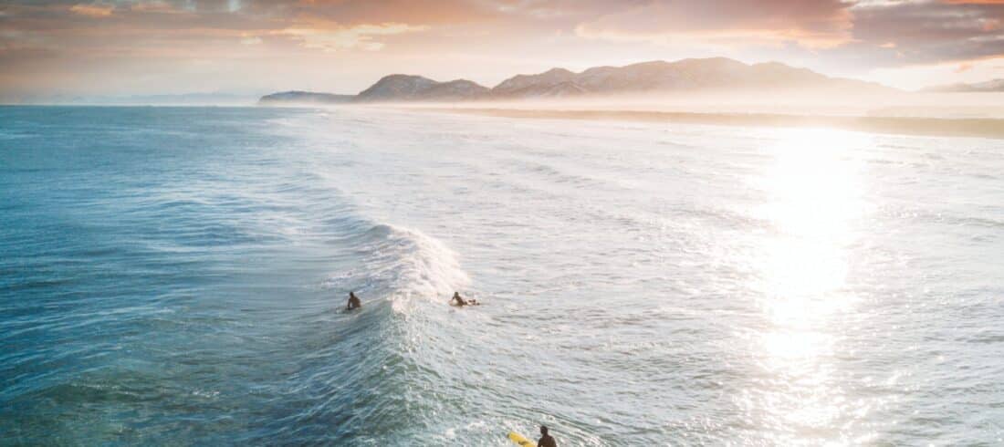 a man riding a wave on a surfboard in the ocean